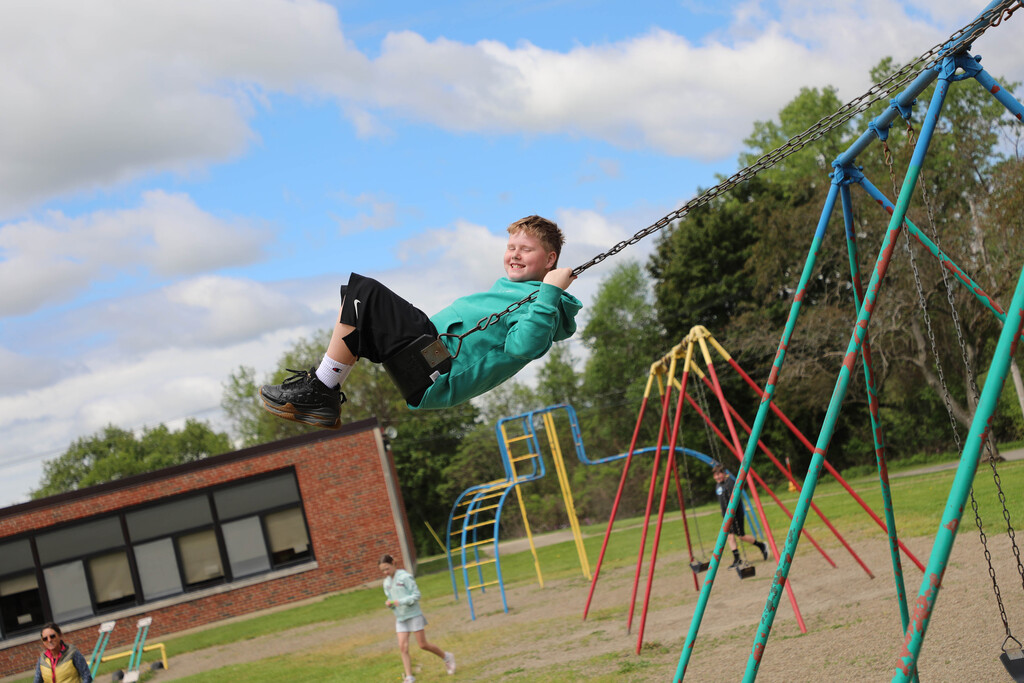A student uses the swings. 