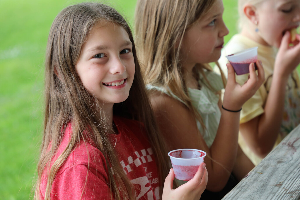 A student drinks a smoothie. 