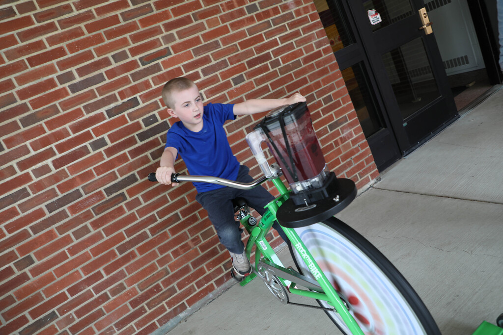 A student uses the smoothie bike. 