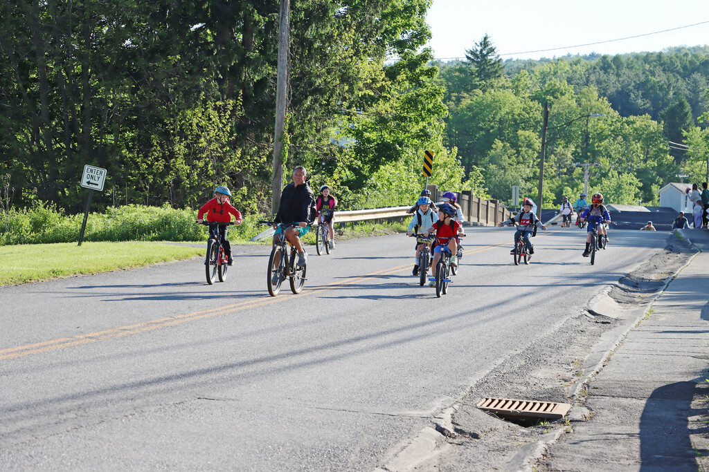 The first students and Mr. S head down the road to the school. 