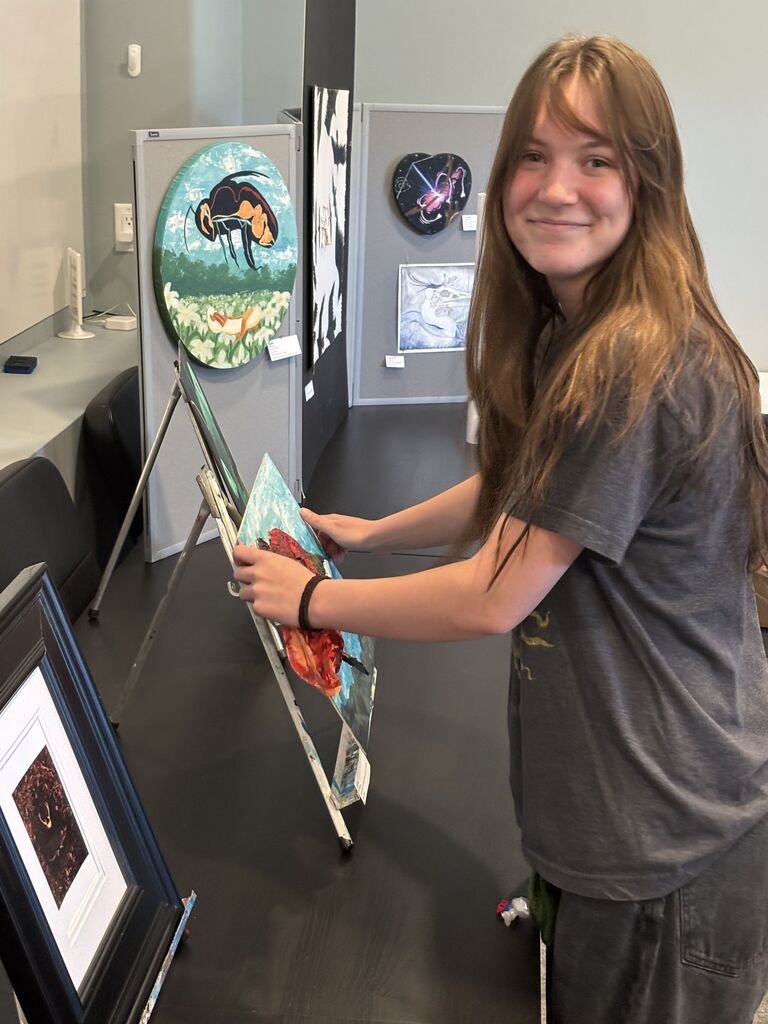 A student with their artwork.