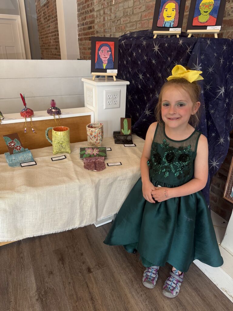 A student with their artwork.