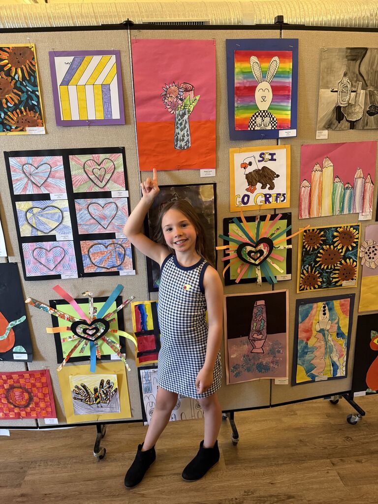 A student with their artwork.