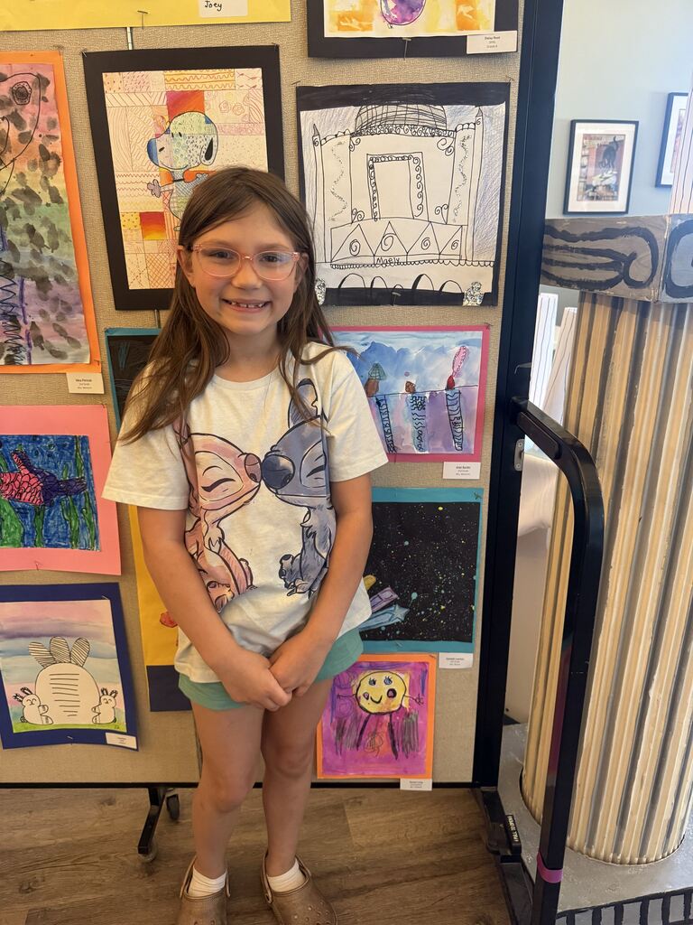 A student with their artwork.