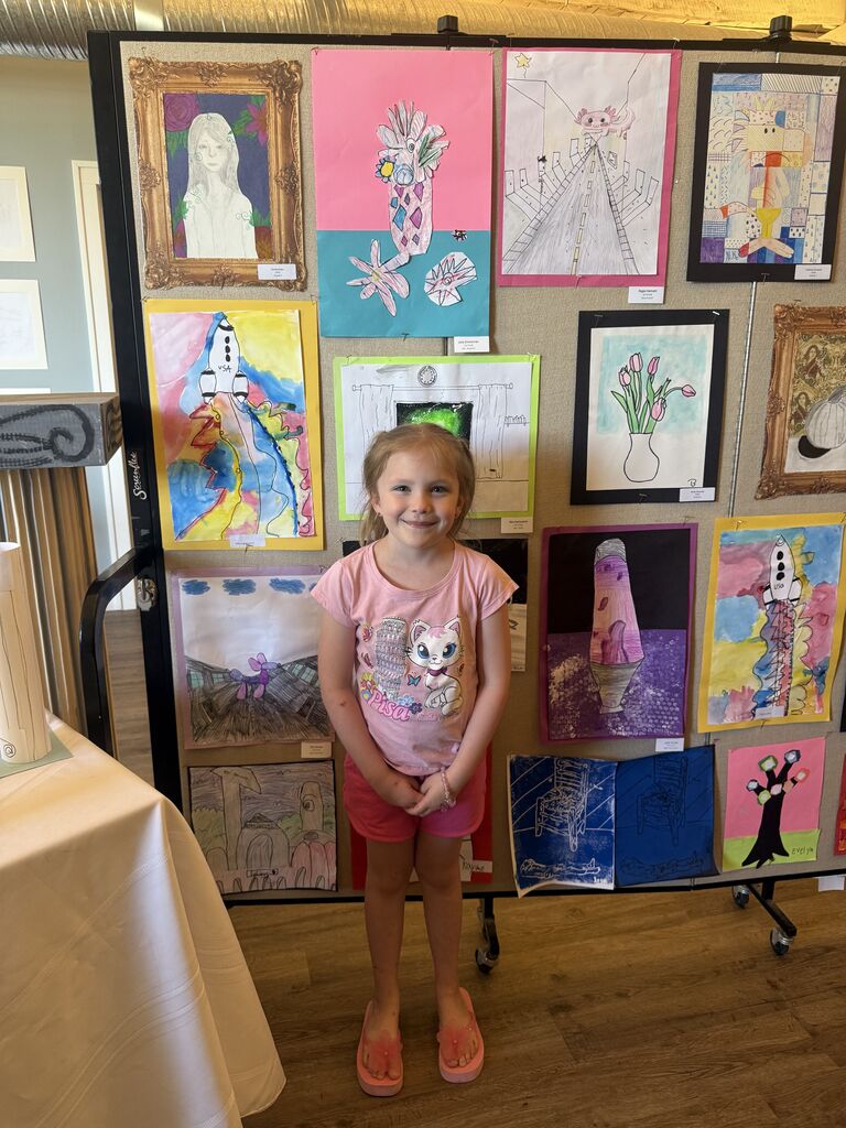 A student with their artwork.