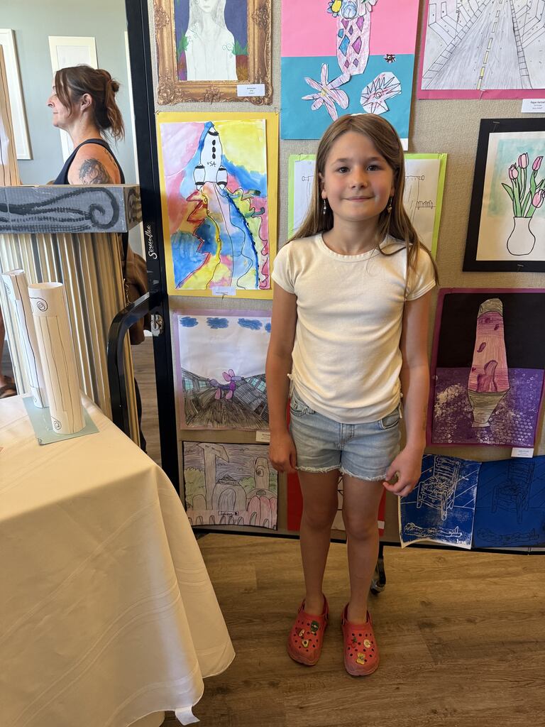 A student with their artwork.