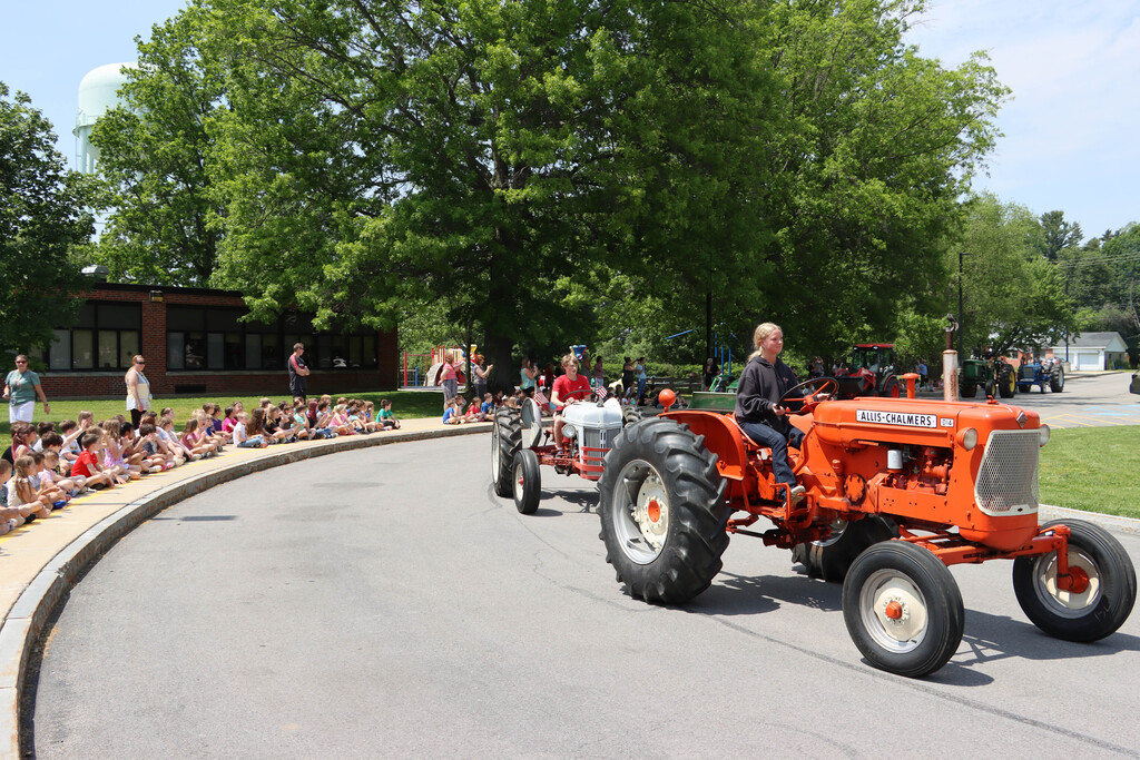 Tractors drive by SES students.