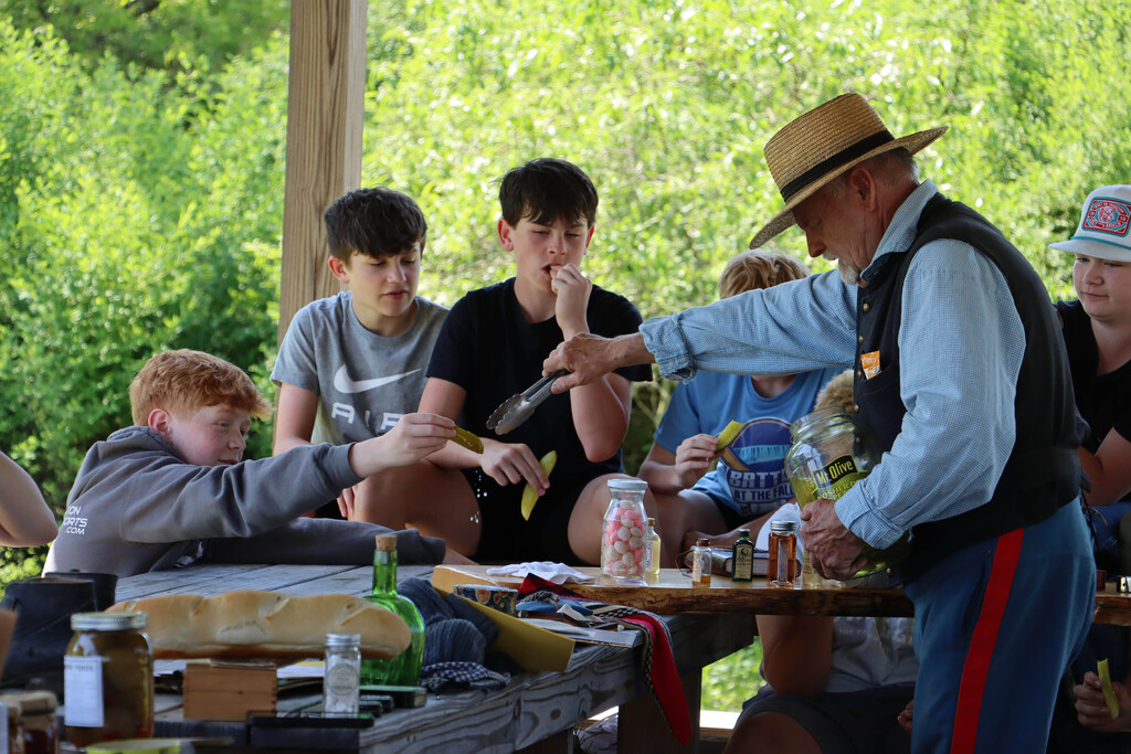 A re-enactor serves pickles.