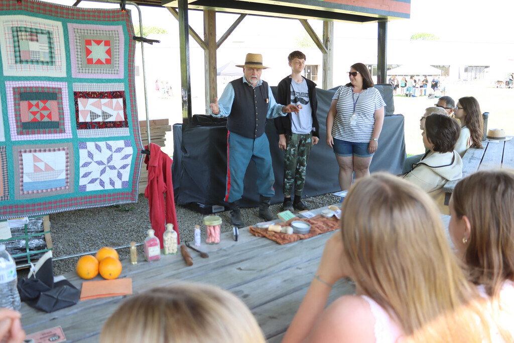 A re-enactor presents to students. 
