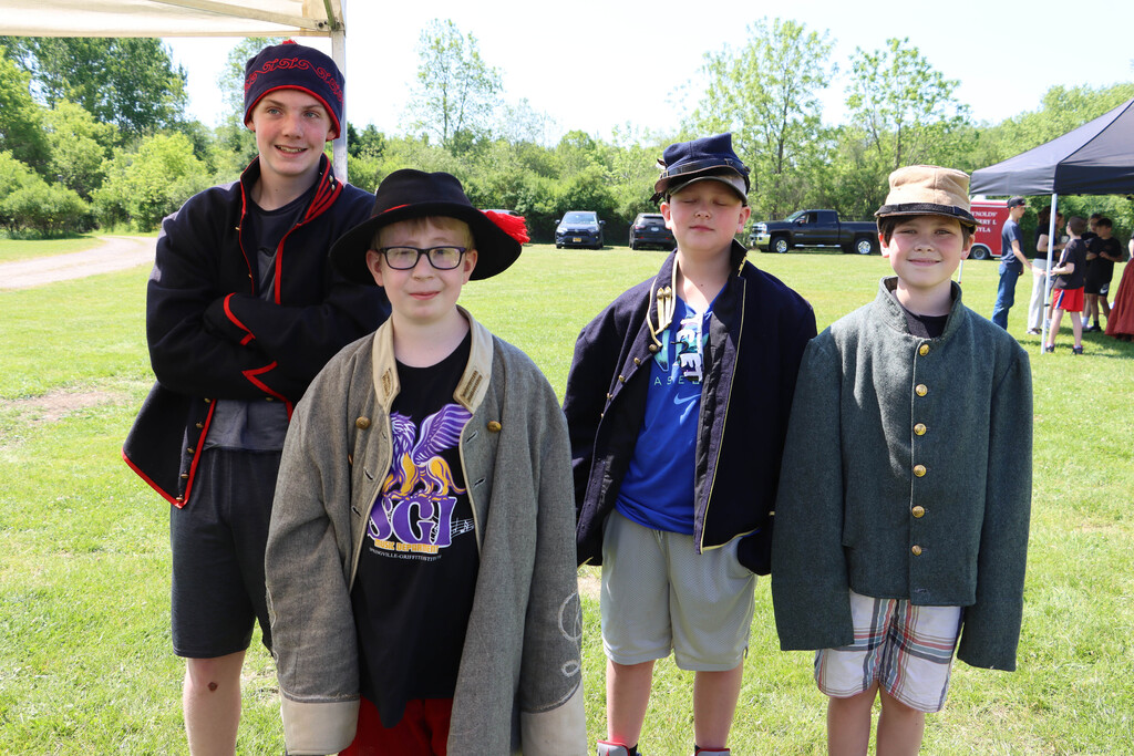 Students wear historic uniforms. 