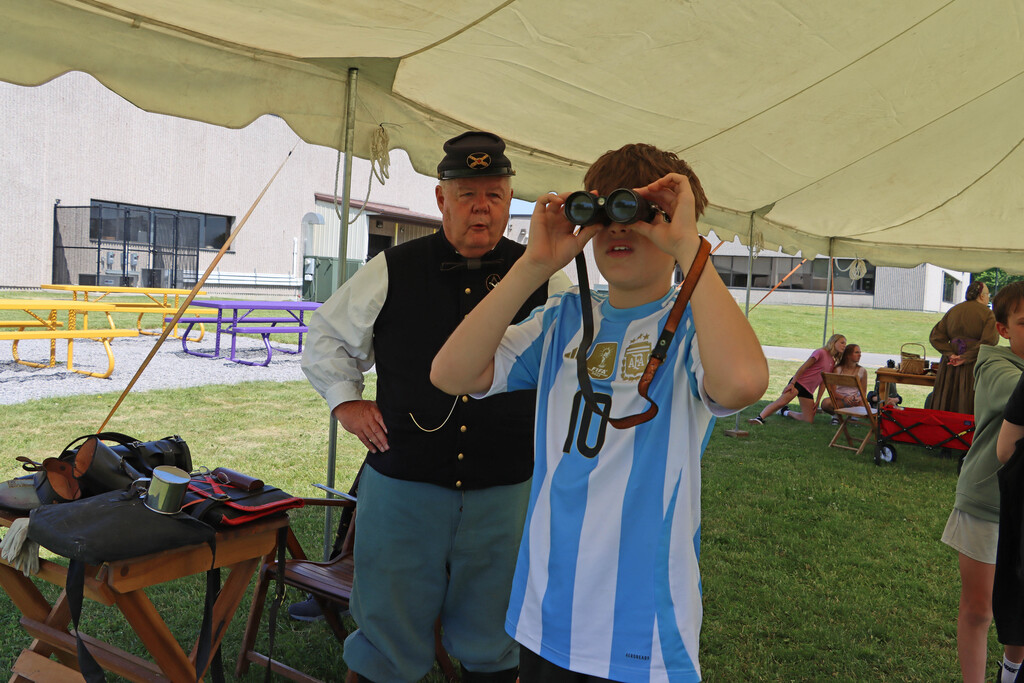 A student looks into binoculars. 