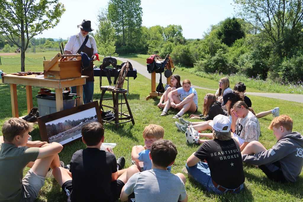 A re-enactor presents to students. 