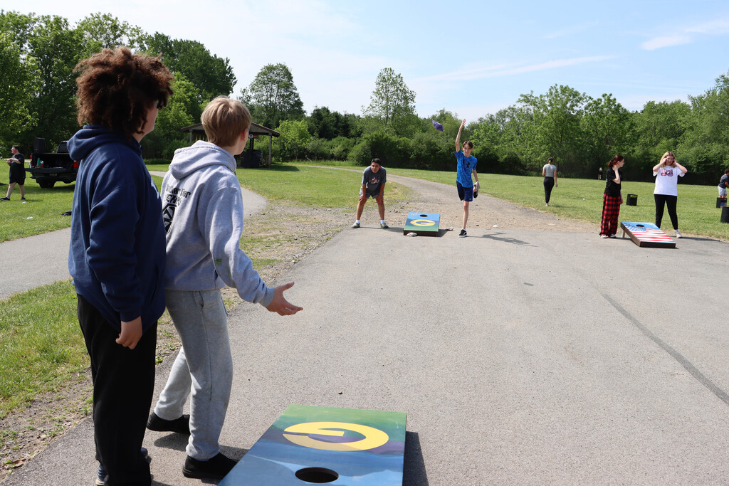 Students play cornhole. 