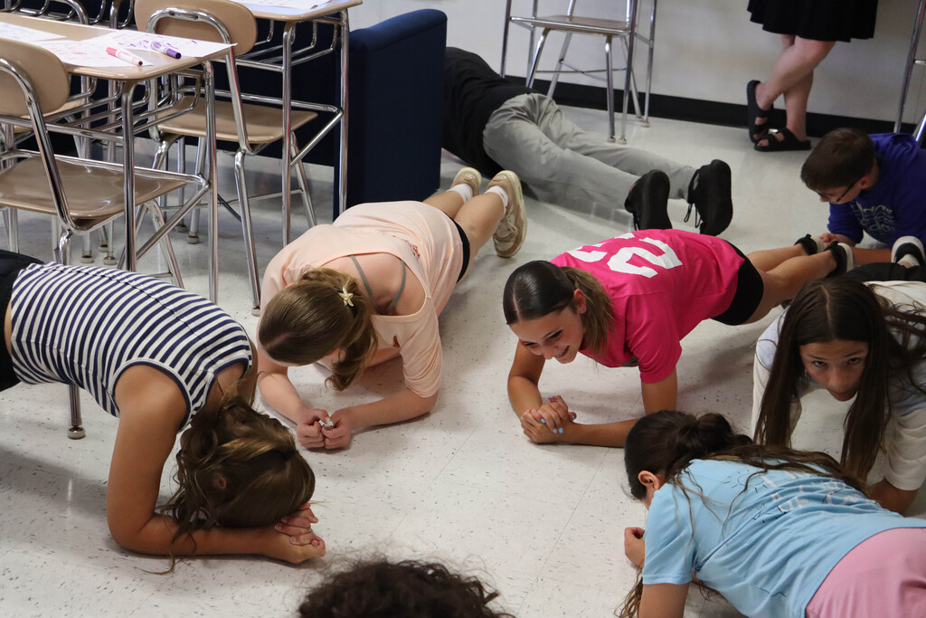 Students do planks for fitness BINGO. 