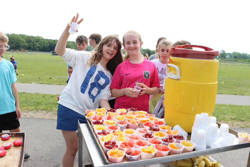 Students enjoy fresh fruit cup snacks. 