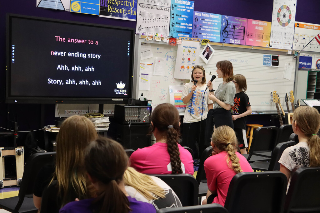 Students sing karaoke. 