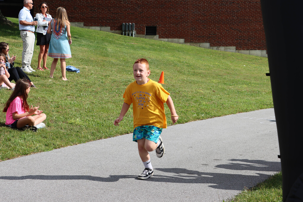 Students run the track. 