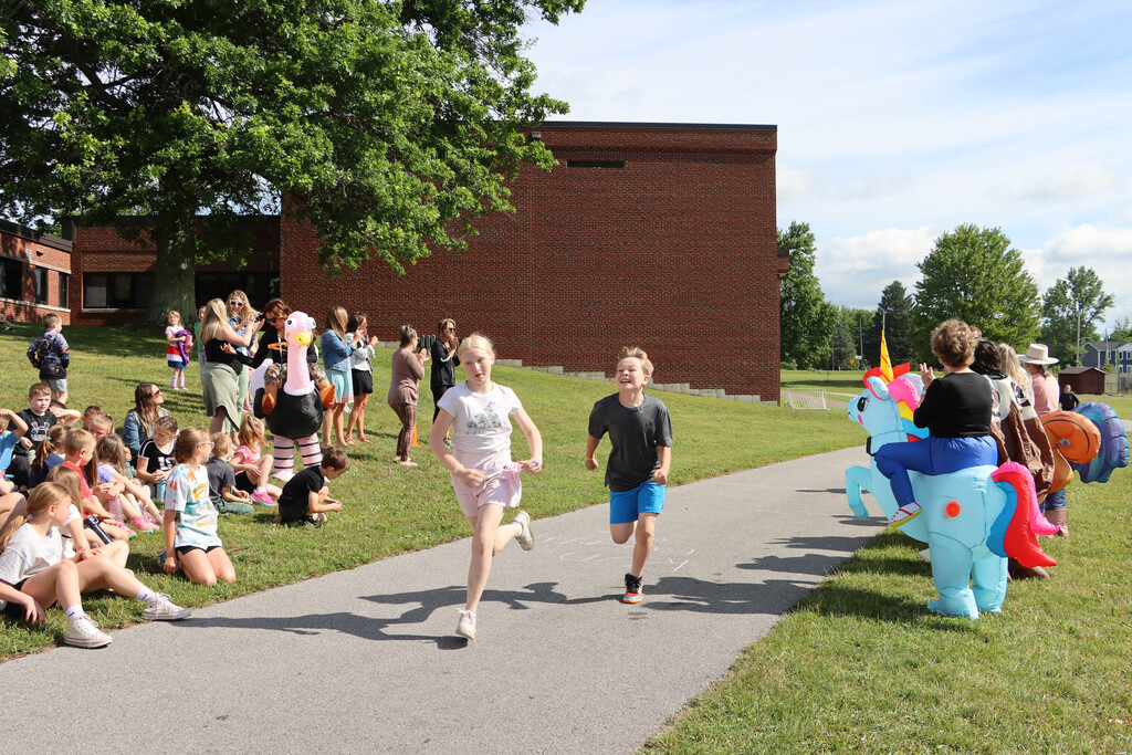 Students run the track. 