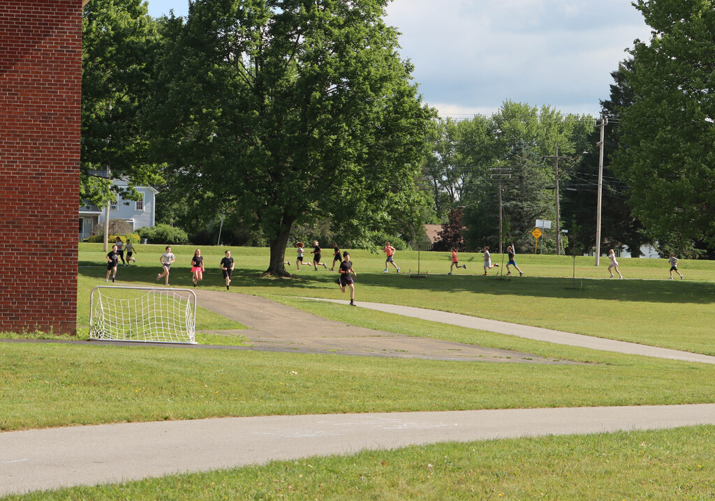 Students run the track. 