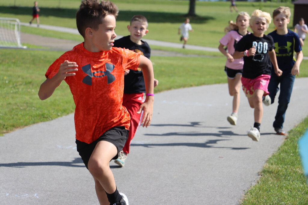 Students run the track. 