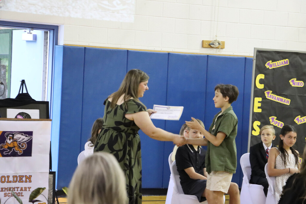 A student accepts their certificate.