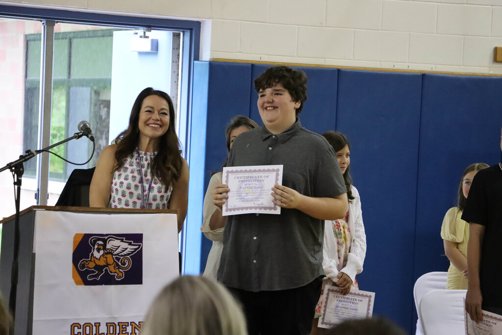 Student accepts their certificate. 