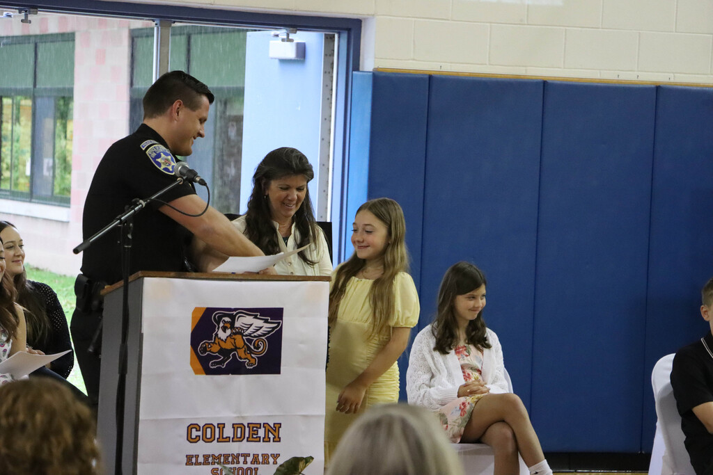 Student accepts their certificate. 