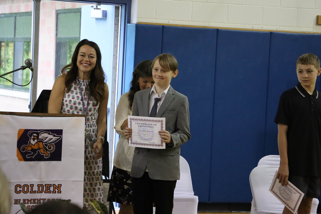 Student accepts their certificate. 