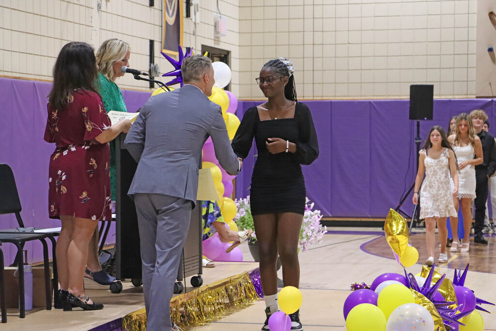 Student accepts their certificate. 