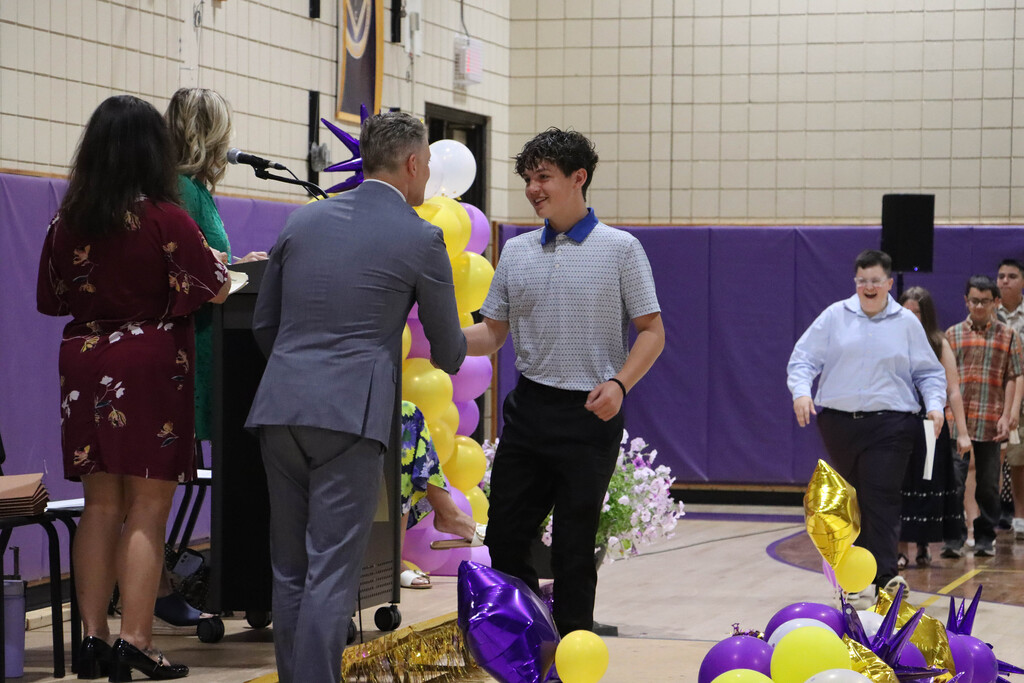 Student accepts their certificate. 