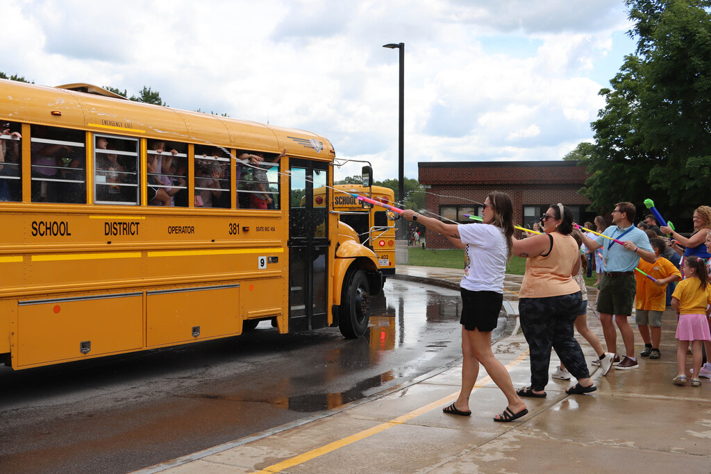 Staff sprays students with water. 