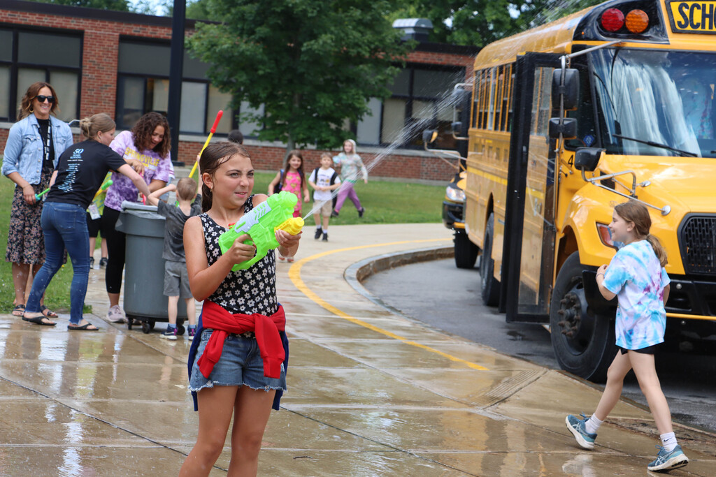 A student fires back with her own water squirter. 