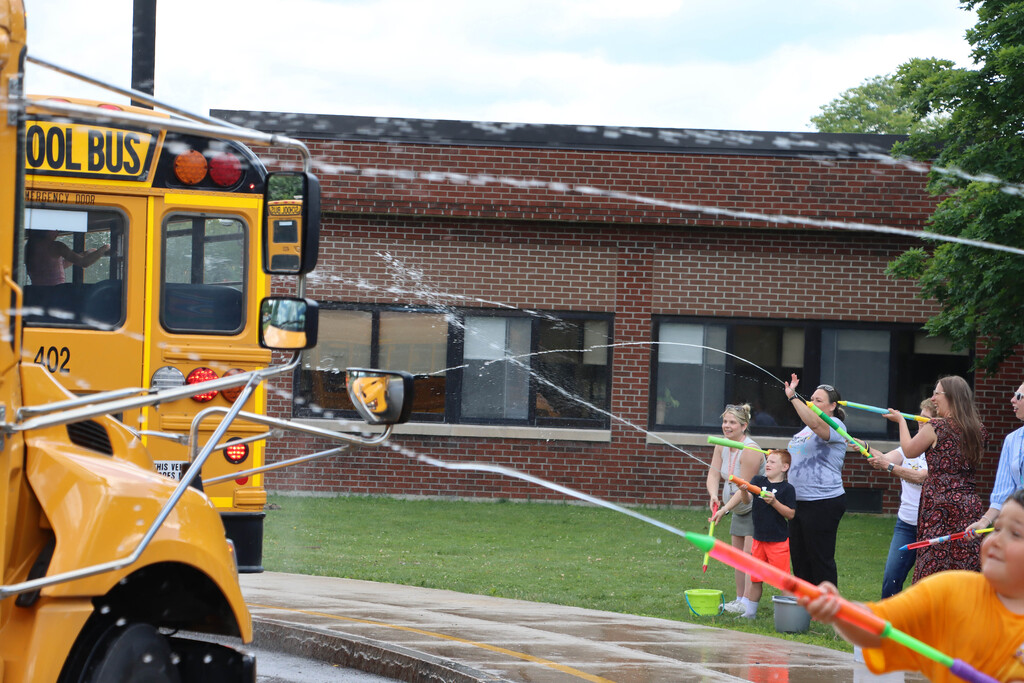 Staff sprays students with water. 