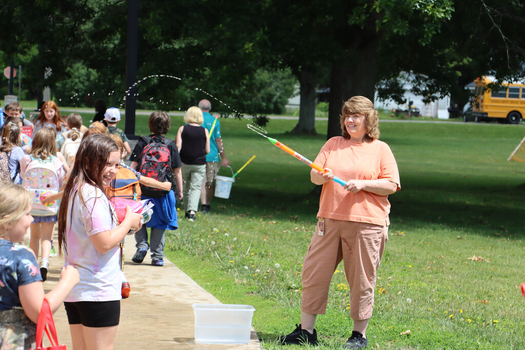 Staff sprays students with water. 