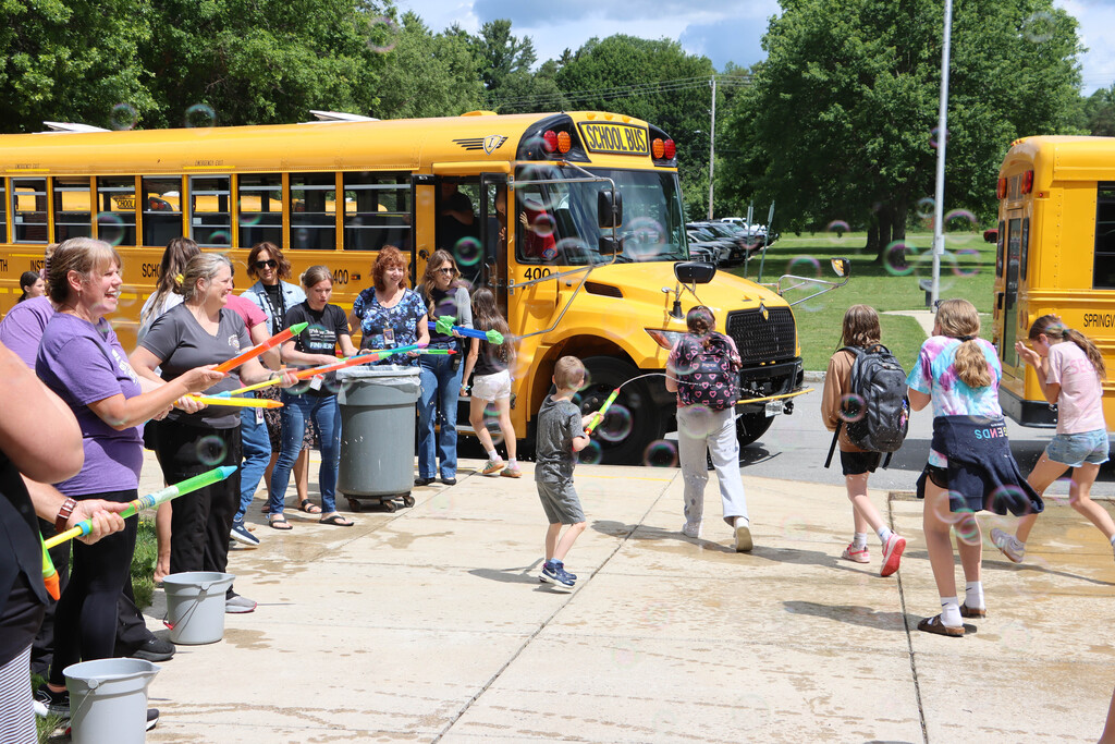 Staff sprays students with water. 