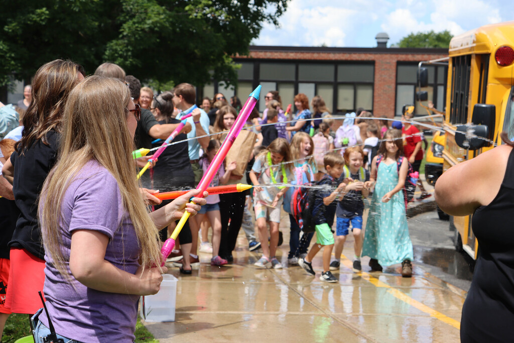 Staff sprays students with water. 