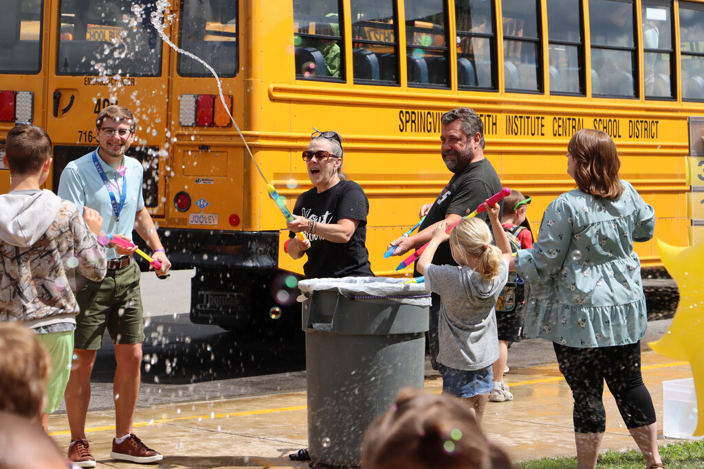 Staff sprays students with water. 