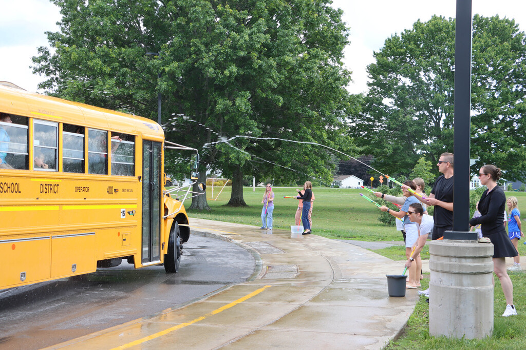 Staff sprays students with water. 