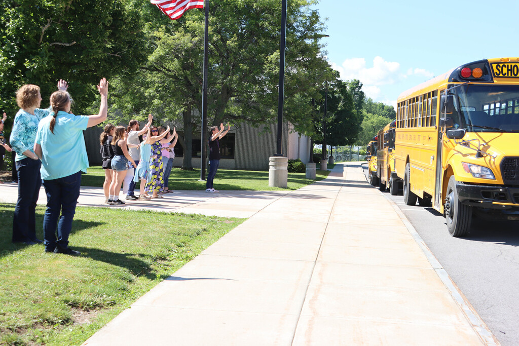 Staff wave off the buses. 