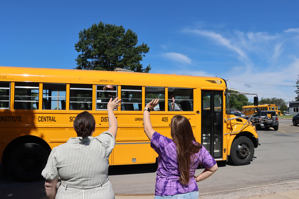 Staff wave off the buses. 