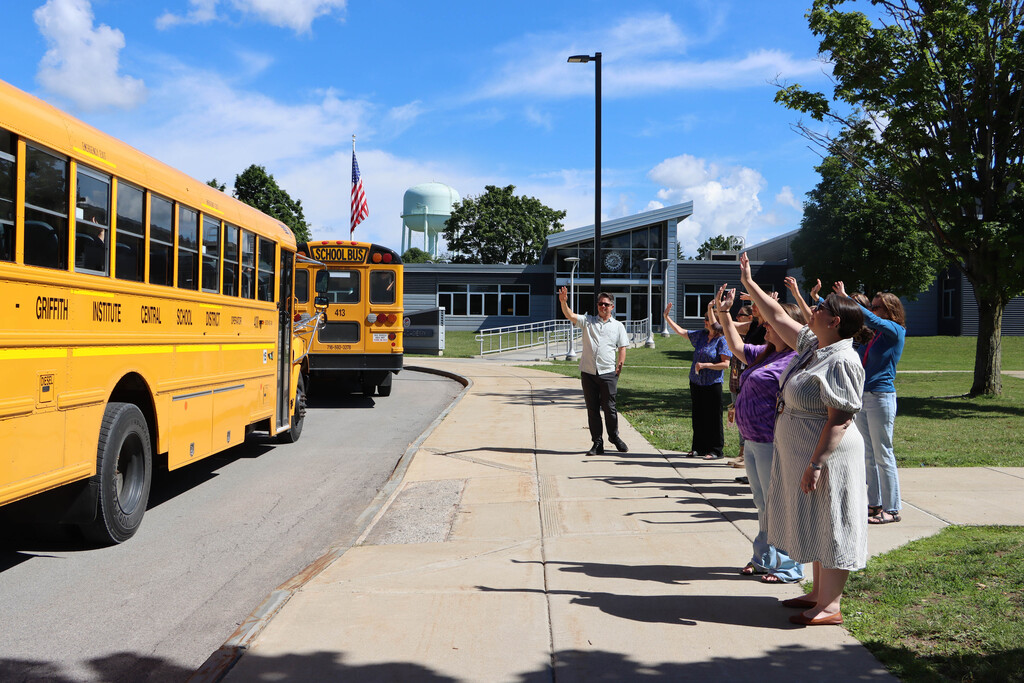 Staff wave off the buses. 