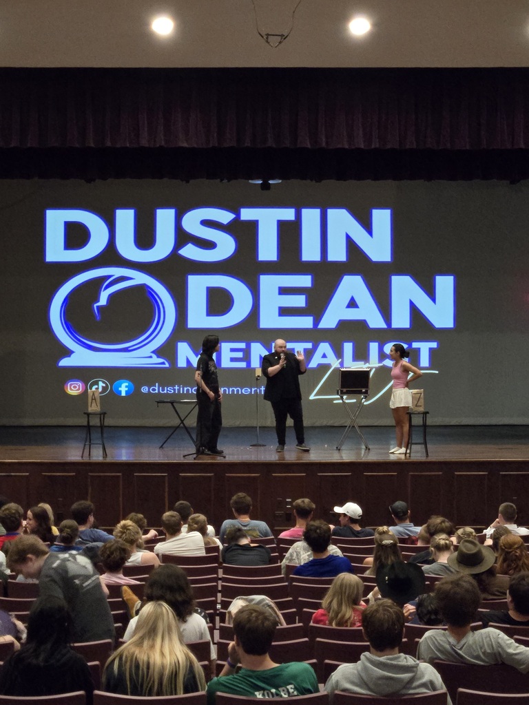 Dustin Dean, Mentalist, calls two students on stage. 