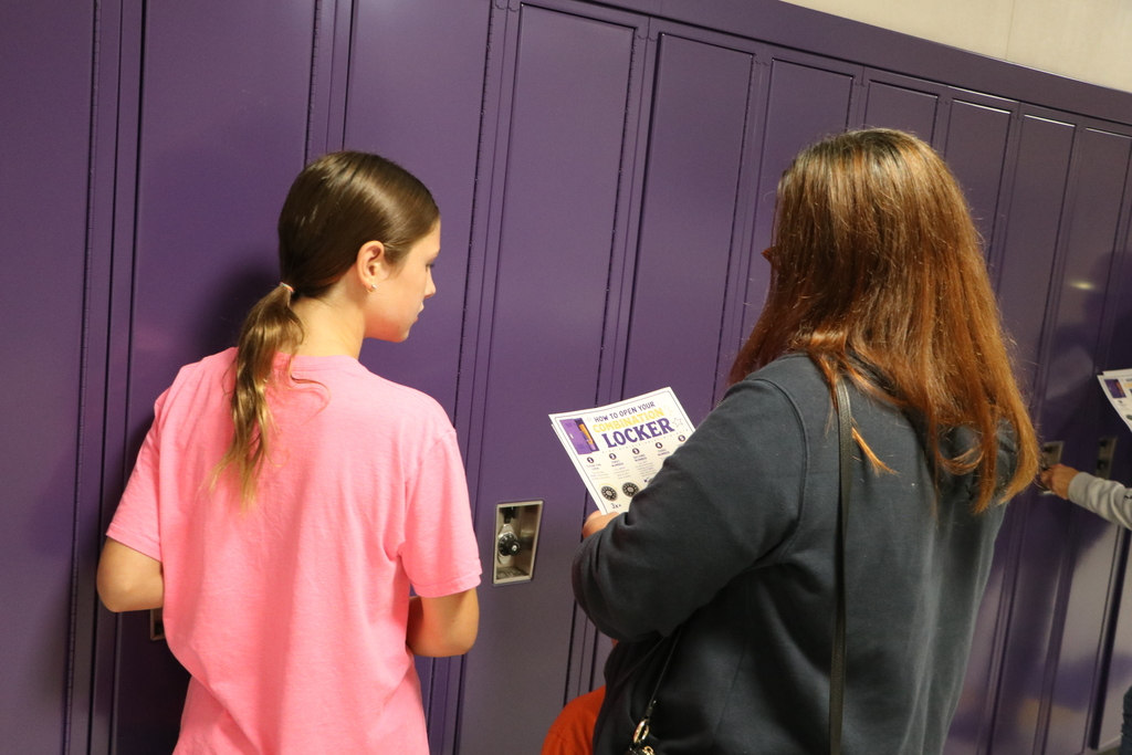 student opens locker