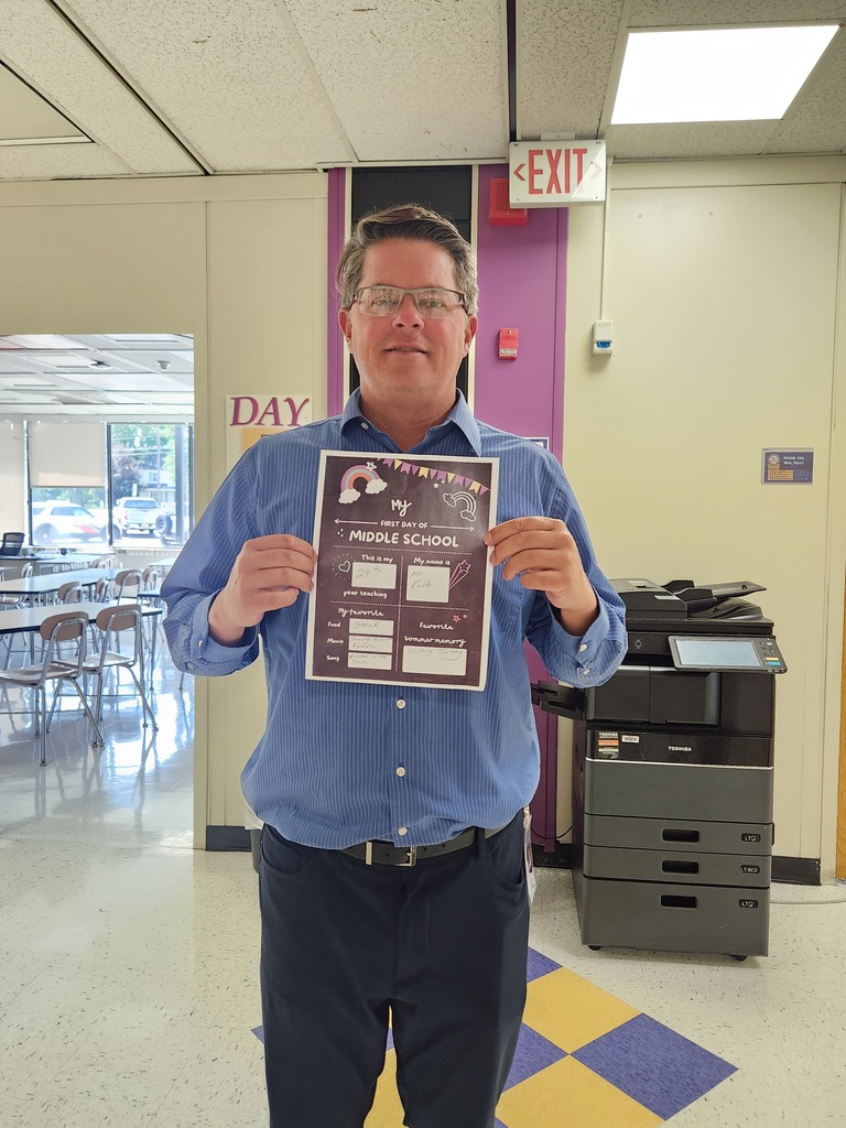 Mr. Karb with his back to school flyer