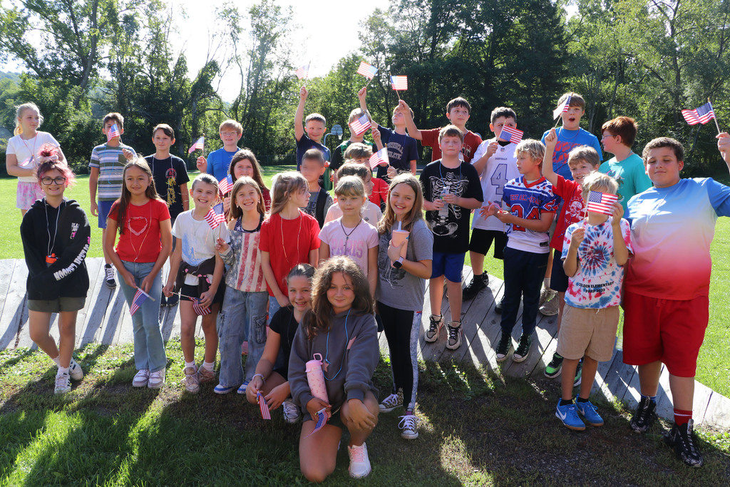 5th graders wave flags before the remembrance walk