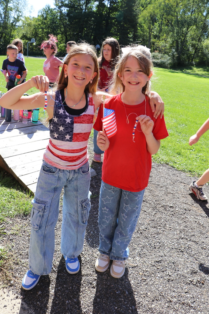 Students hold up their necklaces from the 9-11 remembrance walk.