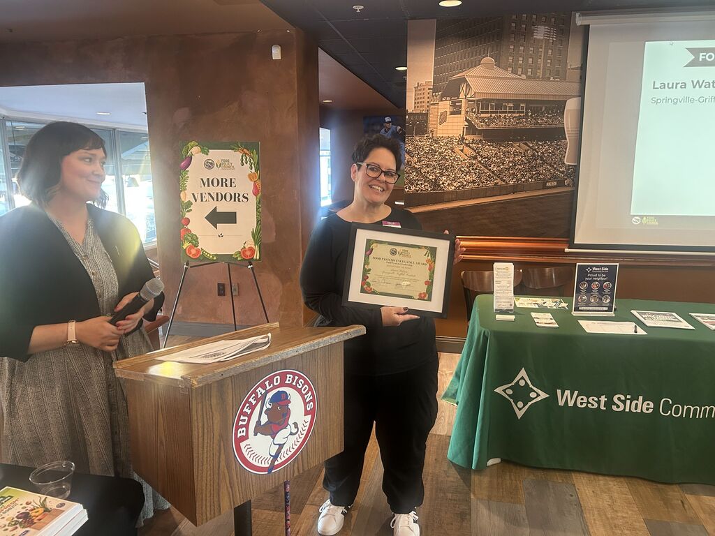 Laura Watson receives award.