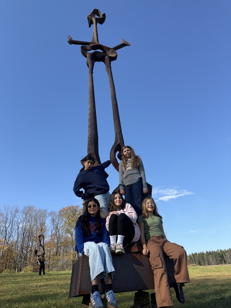 students on a sculpture