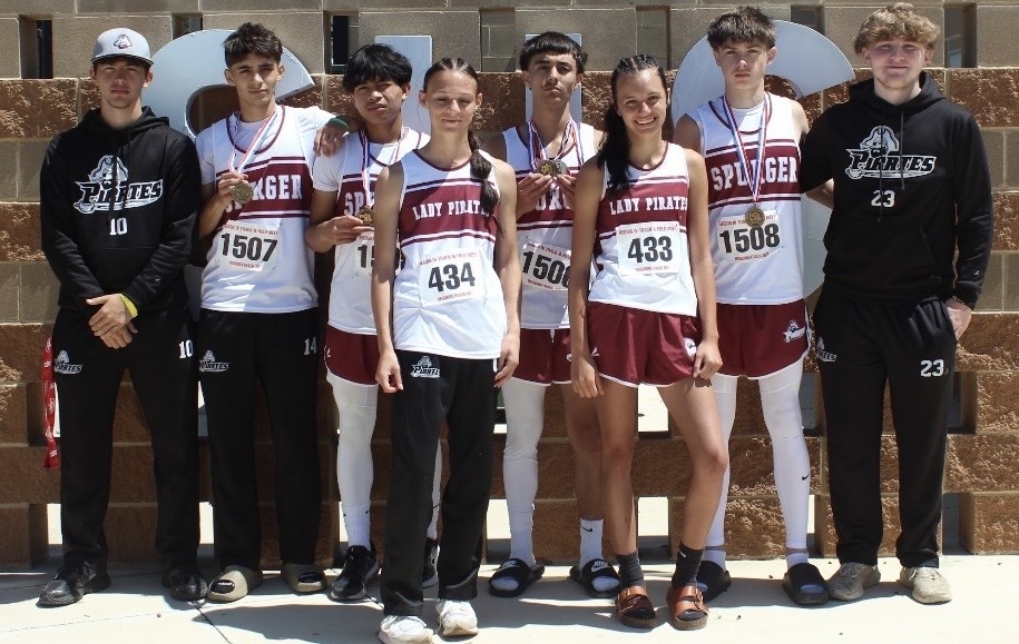Full track team boys and girls with medals standing in a row.