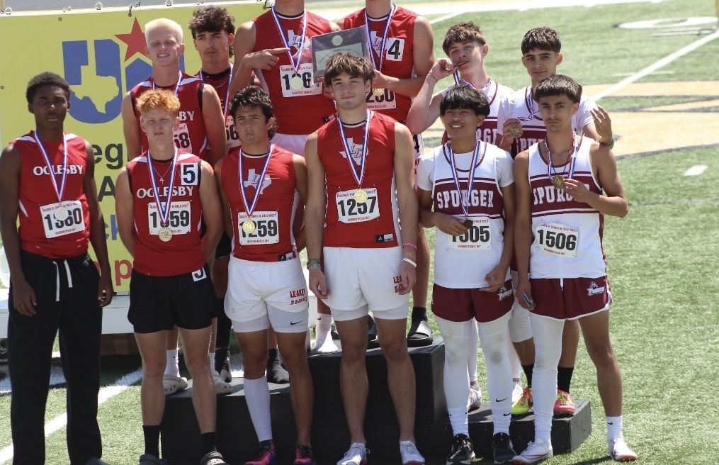 Track team on the medal podium with medals around the necks, some spurger and some other schools.